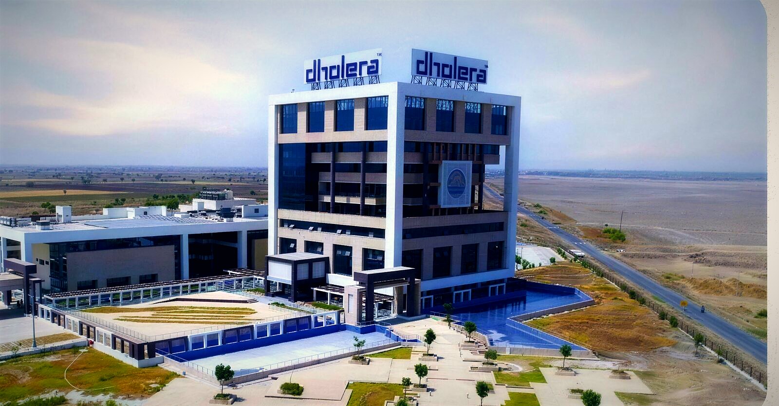 Aerial photograph of the ABCD command and control building in Dholera with open land beside it