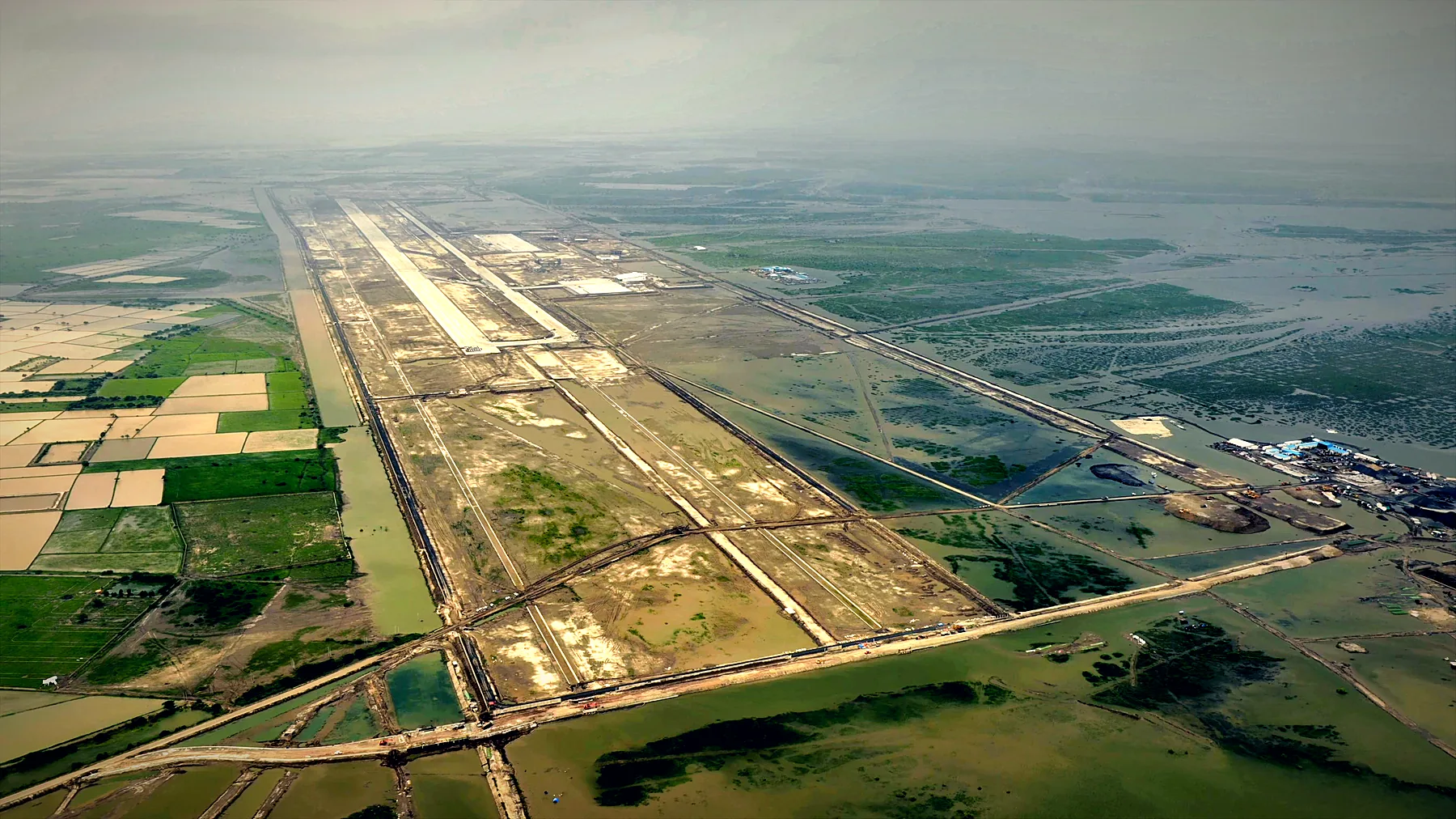 Aerial photo of the full Dholera airport site with the runway set in the flat coastal land of the Bhal region