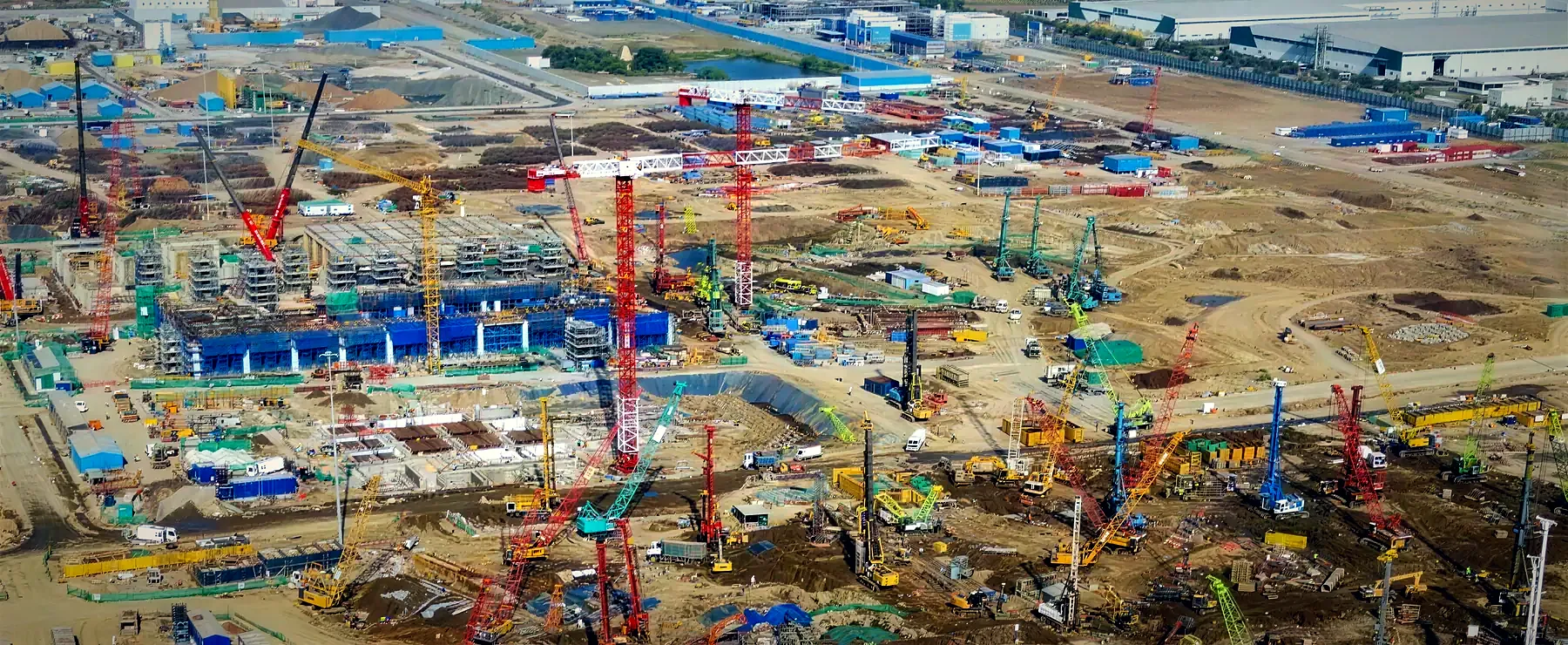 Aerial photo of the Tata fab site at Dholera, crowded with tower cranes and piling rigs around the first blocks of the plant